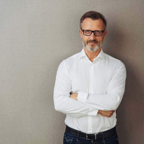 istock Man in glasses and white shirt, arms folded 1248768954