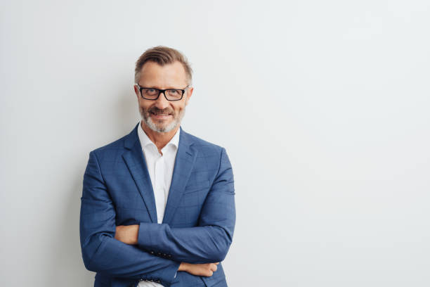 istock Friendly businessman posing with folded arms 1248769132