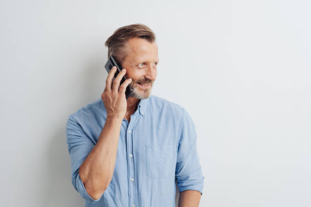 istock Casual man standing chatting on his mobile 1248770296