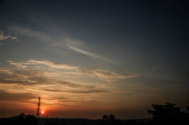 Electric pylon in silhouette in a country sunrise scene
