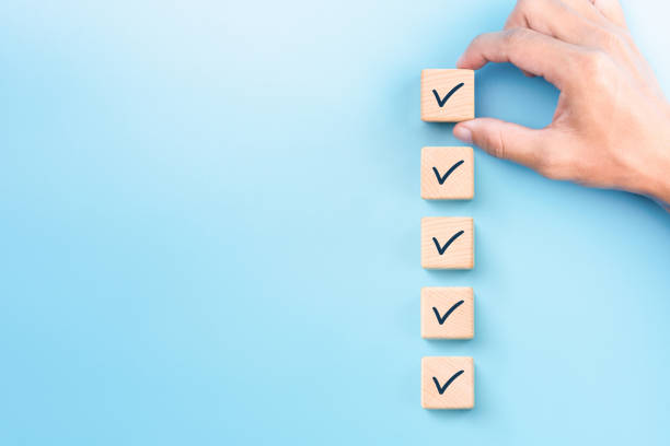 istock Checklist concept, Check mark on wooden blocks, blue background with copy space 1248771007