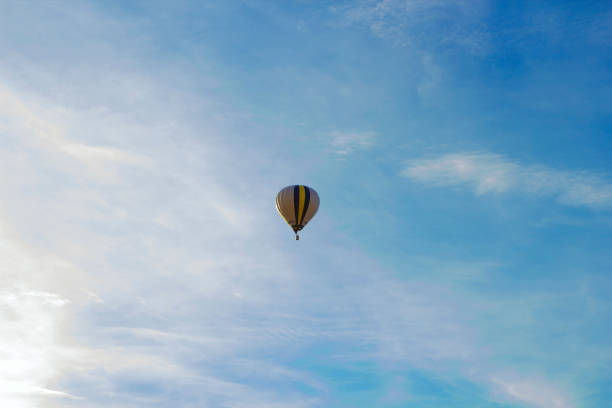 istock Flight of large air balloons against cloudy blue sky 1248771056
