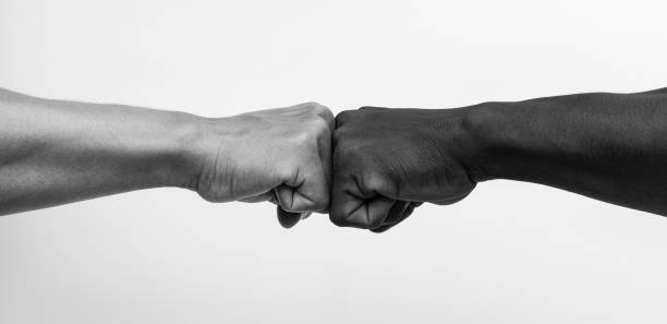 istock Man giving fist bump, monochrome, black and white image. 1248771108
