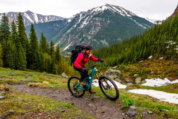 Photo of Female mountain biker rides along mountain ridge