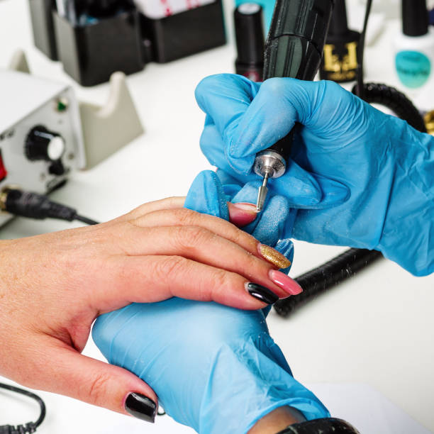 istock Nail salon, hands of client and master. Nail treatment with a cutter 1248773737