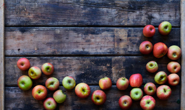 Wooden Surface with apples Wooden Surface with various apple varietals border with copy space apple orchard photos stock pictures, royalty-free photos & images