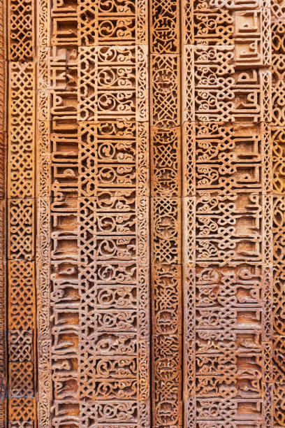 Wall decorative patterns of Qutb complex in South Delhi, India, close up ancient bas relief wall decorations of mosque ruins landmark, popular touristic spot in New Delhi, ancient indian architecture