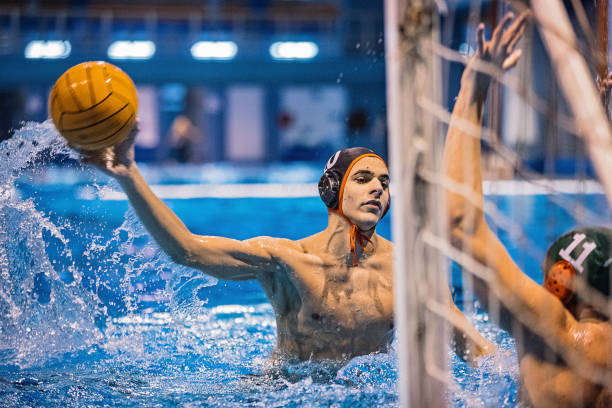 istock Two young men playing water polo 1248778726