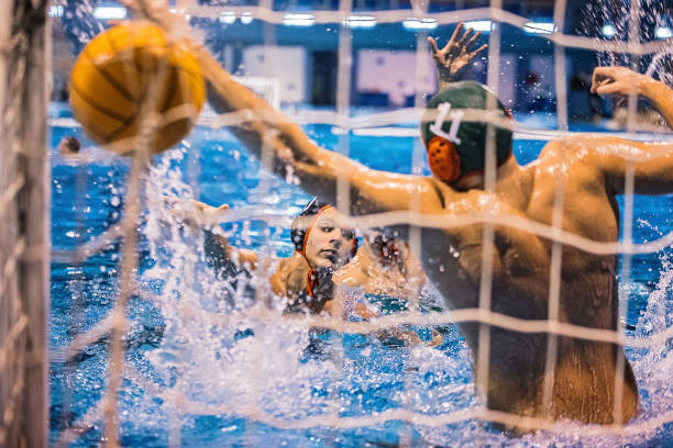 istock Two young men playing water polo 1248778795