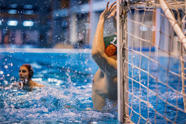 istock Two young men playing water polo 1248778819
