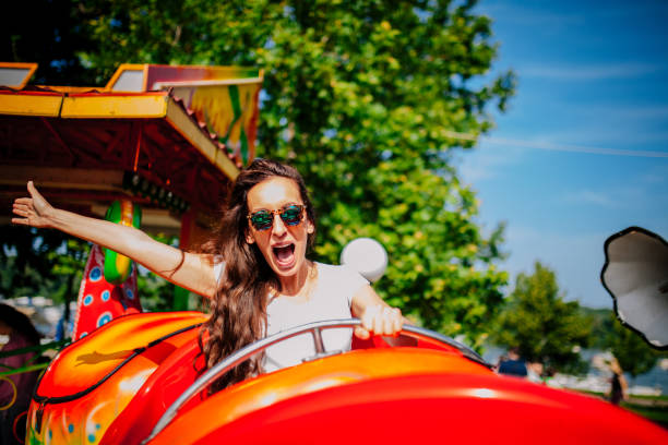 istock Young woman screaming on a rollercoaster 1248779978