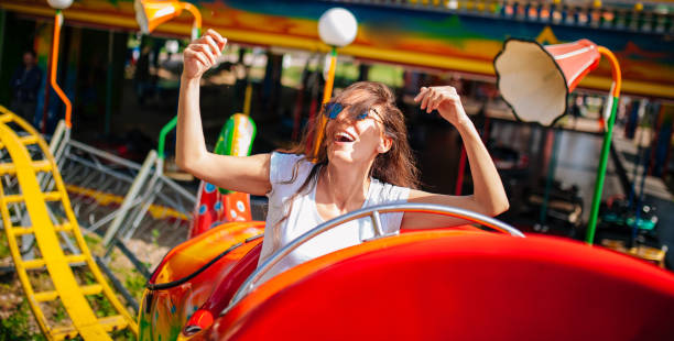 istock Young woman screaming on a rollercoaster 1248779994