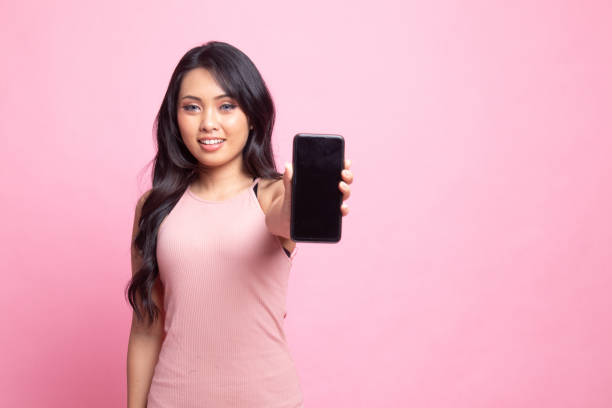 istock Young Asian woman with mobile phone. 1248782082