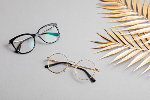 istock Stylish eyeglasses over pastel  background. Optical store, glasses selection, eye test, vision examination at optician, fashion accessories concept. Top view 1248782357