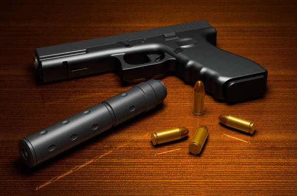 istock Silenced pistol with bullets on the wooden table. 3D rendering 1248782737