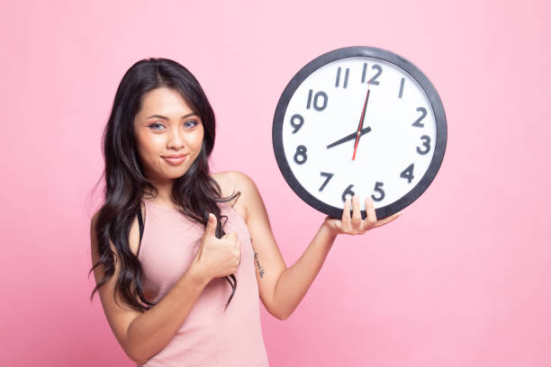 istock Young Asian woman thumbs up with a clock. 1248784788