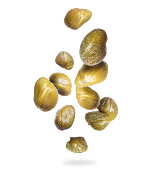 istock Capers frozen in air close up on a white background 1248786414