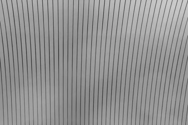 Striped black and white background image. Ceiling fragment made with rack panels. Soft focus.