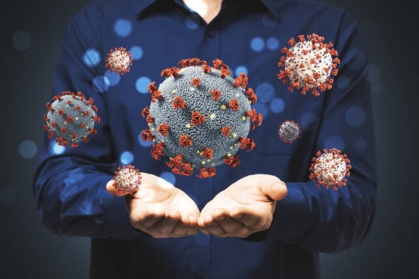 istock Man holds in his hands virus cells coronavirus 1248786683