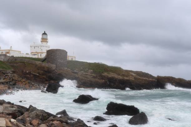 istock White lighthouse and stormy sea 1248788696