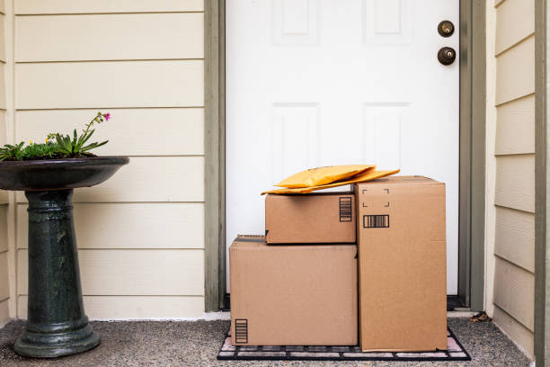 Front Door with Delivery Boxes Front Door of House with Stack of Delivery Boxes from Online Ordering and E-commerce buy gift in usa stock pictures, royalty-free photos & images