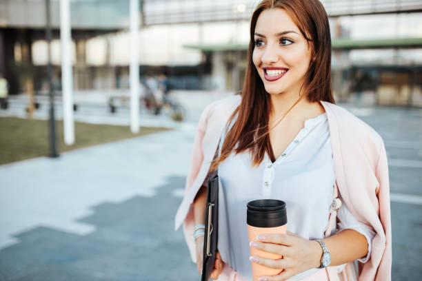 istock Young student in front of her place of work having a cafe break. 1248791069