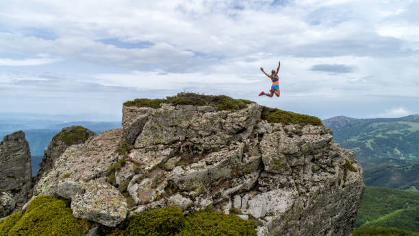 istock Young woman running on mountain 1248791973