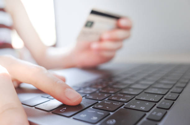 istock Hands holding plastic credit card and using laptop. Online shopping concept. 1248794125