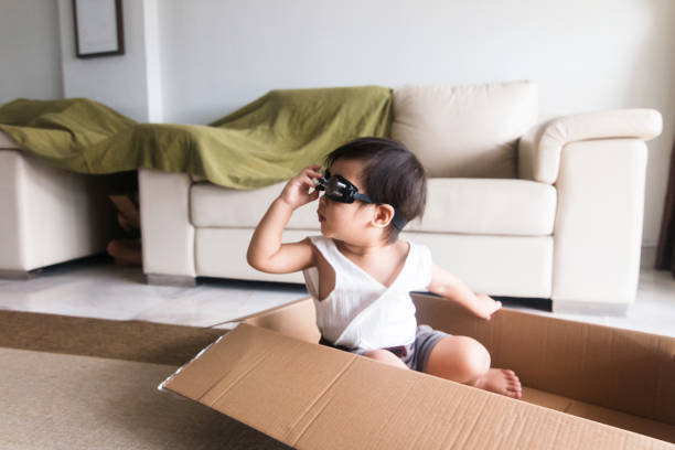 istock Toddler boy wears goggles and plays in card board box 1248803238