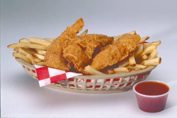 Chicken Tenders and french fries in a basket stock photo