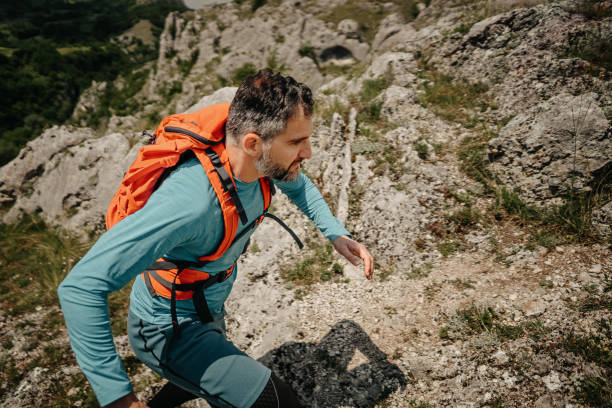 istock Man running on rocky hill 1248805816