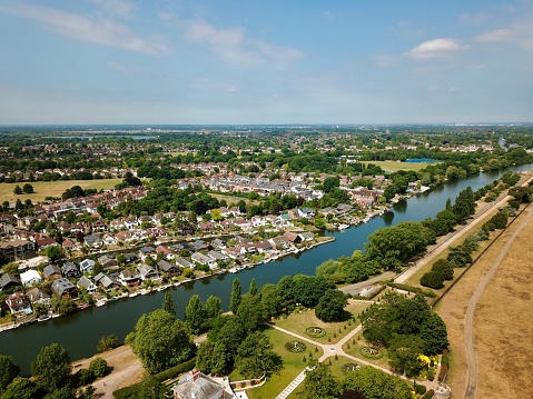 The drone aerial view of Thames river runs through the Thames Ditton and Hampton court