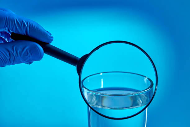 specialist examine or check water quality over blue background. eco friendly concept. test water pollution concept.