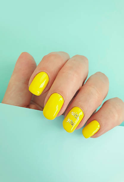 istock female hand beautiful manicure on a colored background 1248807761