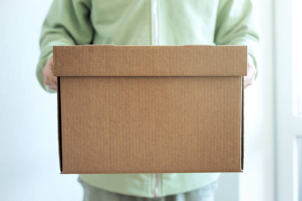 istock Deliveryman giving shipping box 1248807788