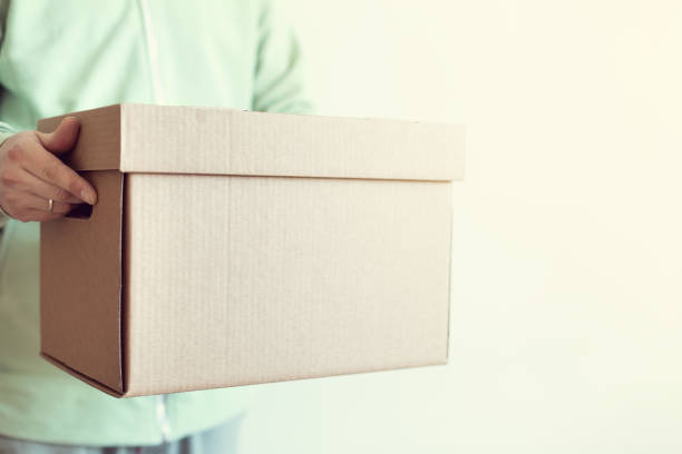 istock Deliveryman giving shipping box 1248807793
