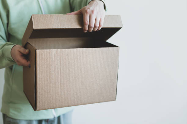 istock Deliveryman giving shipping box 1248807800
