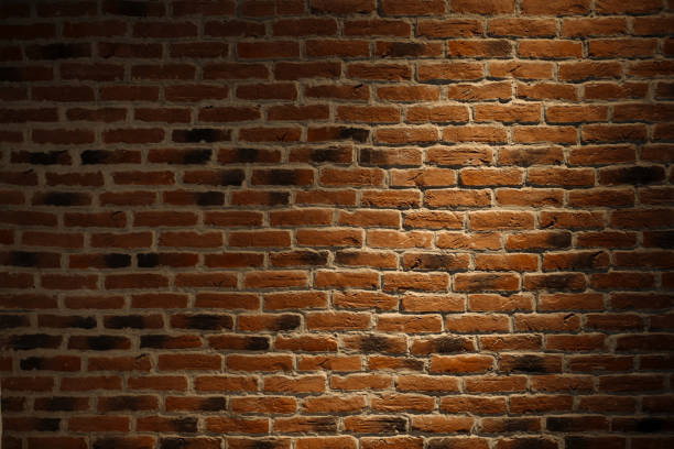 istock Texture of a brick wall with a light spot. 1248812009
