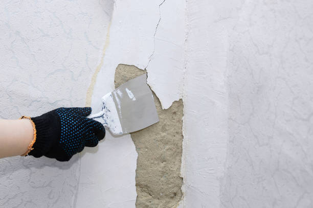 istock Home improvement. Repair a damaged wall in a room. Plasterer at work. 1248812173
