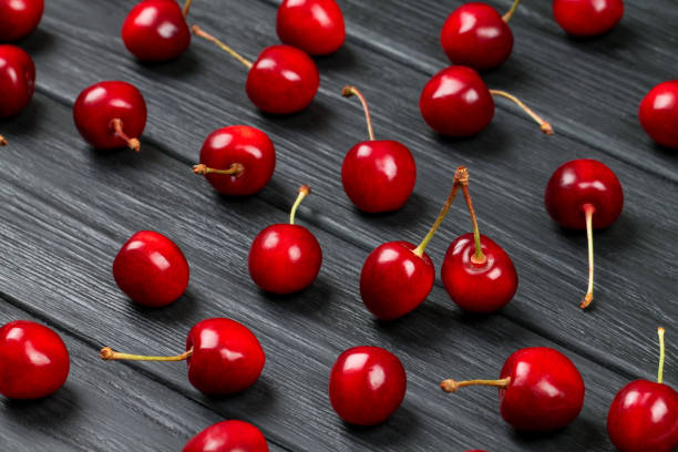 istock Ripe red cherries are scattered on the table. 1248812812