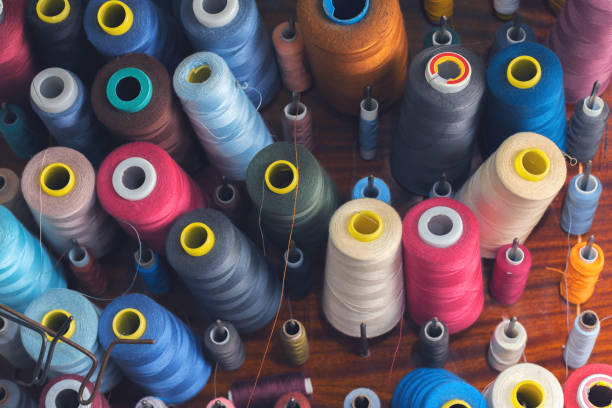 istock Colored thread on bobbins in a sewing workshop. Garment industry concept 1248816153