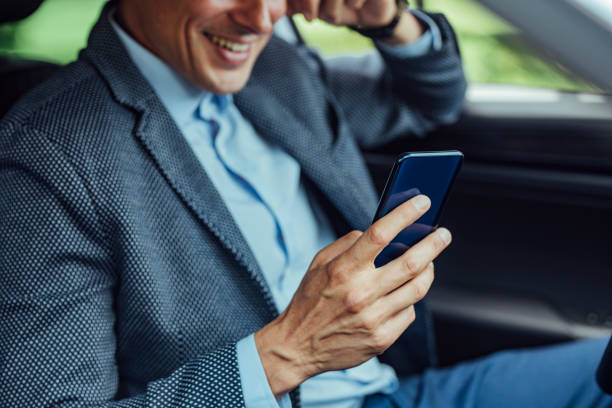 istock Technology in the Car: a Businessman Texting While Sitting in the Driver's Seat 1248817589