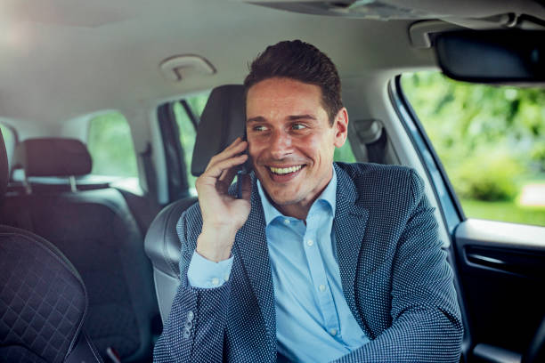 istock Happy Handsome Businessman Making a Phone Call in the Car 1248817607