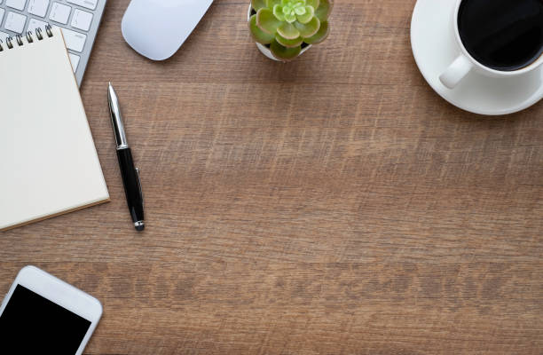 istock Wood office desk table with keyboard, notebook and coffee cup with equipment other office supplies. Business and finance concept. Flat lay with blank copy space. 1248825047