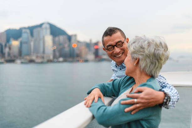 active chinese seniors enjoying view at ocean terminal deck - harbour city imagens e fotografias de stock