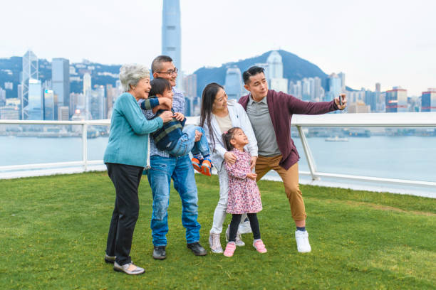 istock Smiling Chinese Family Taking Selfie at Ocean Terminal Deck 1248826300