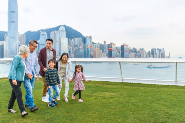 chinese family enjoying city views from ocean terminal deck - harbour city imagens e fotografias de stock