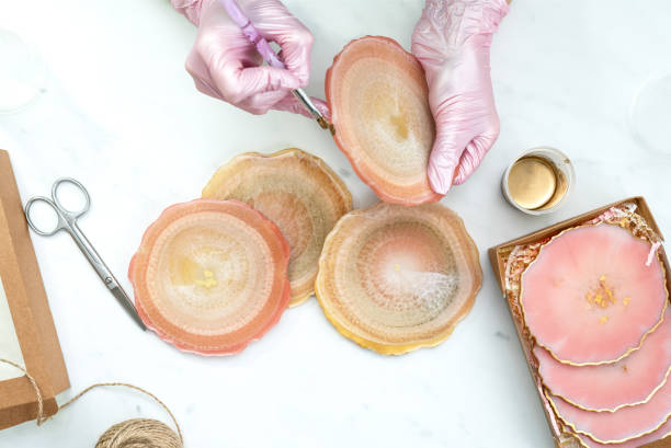 istock Creativity and craft. A young girl creates coasters from resin. Gift wrapping. Decorative packaging. Idea for business. Remote work, work at home. Art coasters. 1248826361