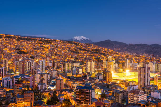 La Paz, Bolivia, Panoramic View of Cityscape and Illimani Mountain at Night La Paz, Bolivia, panoramic view of La Paz cityscape and Illimani mountain at night. bolivian andes photos stock pictures, royalty-free photos & images