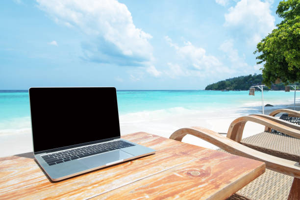 istock Mobile work office on the beach with blank laptop screen 1248832503